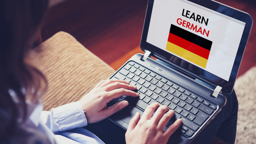 Female Learning German at home with a laptop.